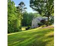 Well-maintained backyard featuring lush green grass and a brick home in the background at 4829 Moon Rd, Powder Springs, GA 30127