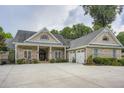 Beautiful brick home with an attached two-car garage, a charming front porch, and an elegant, arched double-door entrance at 4829 Moon Rd, Powder Springs, GA 30127