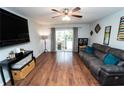 Spacious living room with wood floors, ceiling fan and sliding glass doors to backyard at 5400 Roswell Rd # K2, Atlanta, GA 30342