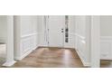 Bright foyer with beautiful columns, hardwood floors, and white wainscoting at 9744 Spyglass Dr, Villa Rica, GA 30180