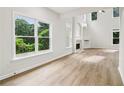 Bright living room featuring vaulted ceilings, large windows, and a fireplace at 9744 Spyglass Dr, Villa Rica, GA 30180
