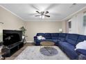Cozy living room features a large blue sectional sofa, ceiling fan, and neutral walls for relaxation at 1066 Wedgewood Ln, Tucker, GA 30084