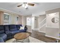 Inviting living room featuring a comfortable blue sofa and stairs to the upper level at 1066 Wedgewood Ln, Tucker, GA 30084