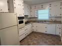 Functional kitchen with white cabinets, updated appliances, and ample counter space at 2990 Piedmont Dr, Marietta, GA 30066