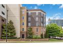 Exterior building showcasing the architecture, landscaping, and signage, with surrounding greenery and blue sky backdrop at 390 17Th Nw St # 6055, Atlanta, GA 30363