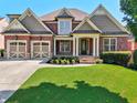 Beautiful brick home features a two-car garage and manicured front lawn at 4050 Bonnett Creek Ln, Hoschton, GA 30548