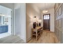 Charming entryway features light wood floors, decorative trim, and a view into the bathroom at 7310 Winderlea Ln, Cumming, GA 30040