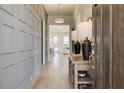 Inviting foyer showcases wood floors, decorative trim, and an open floorplan to the living spaces at 7310 Winderlea Ln, Cumming, GA 30040