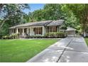Well-maintained ranch style home with a driveway leading to a gated carport at 4309 King Valley Se Dr, Smyrna, GA 30082