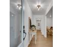 Bright foyer featuring gleaming hardwood floors and elegant light fixture at 4309 King Valley Se Dr, Smyrna, GA 30082