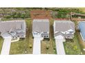 Birds-eye view of a house with a long driveway, surrounded by green lawns and other houses in the neighborhood at 895 Garnet Dr, Acworth, GA 30101