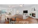 Bright, open living room with hardwood floors, fireplace, and ample natural light at 651 Coligny Ct, Atlanta, GA 30350