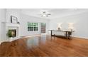 Bright and airy living room with fireplace, hardwood floors, and large windows at 651 Coligny Ct, Atlanta, GA 30350
