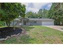 Inviting single-story home featuring neat landscaping, a covered porch, and an attached two-car garage at 3181 Woodbridge Ct, Snellville, GA 30039