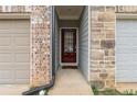 Inviting front entry with a red door, brick accents, and neutral siding, creating a warm welcome at 382 Mulberry Se Row, Atlanta, GA 30354