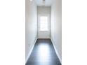 Clean hallway with a white door, light walls, and dark hardwood flooring at 382 Mulberry Se Row, Atlanta, GA 30354