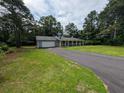 Exterior view of the house showcasing the driveway, lawn and welcoming front porch at 446 Westbrook Rd, Carrollton, GA 30116