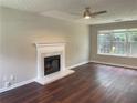 Inviting living room featuring a classic fireplace, wood floors, and ample natural light at 5465 Twin Lakes Dr, College Park, GA 30349