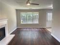 Bright living room with fireplace, wood floors, and an open layout to the backyard at 5465 Twin Lakes Dr, College Park, GA 30349