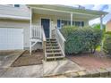 Inviting front entrance with a covered porch, stairs, and a two-car garage at 520 White Pines Dr, Dallas, GA 30157