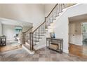 Welcoming home entryway with tile flooring, staircase with iron railings, and decorative table at 5349 Forest Springs Dr, Dunwoody, GA 30338