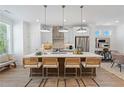 Bright kitchen with a quartz island, stainless steel appliances, and sleek pendant lighting at 630 Skytop Dr # 157, Cumming, GA 30040