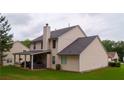 View of backyard with covered patio and a chimney at 1332 Chandler Cove Way, Grayson, GA 30017