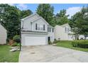 Charming home with two-car garage, black shutters, basketball hoop, and manicured lawn at 2512 Halcyon Way, Lawrenceville, GA 30044
