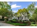 Charming two-story home with lush landscaping and mature trees enhancing curb appeal at 1017 Mill Creek Ne Mnr, Brookhaven, GA 30319