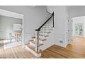 Elegant staircase with wood treads, white risers and beautiful contrasting dark stained handrail at 1017 Mill Creek Ne Mnr, Brookhaven, GA 30319