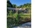 A statue accents the gate, adding to this home's classic appeal at 435 Johnson Ferry Nw Rd, Atlanta, GA 30328