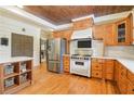 Well-equipped kitchen with stainless steel appliances, custom wood cabinets, and hardwood floors at 150 Henderson Farm Dr, Woodstock, GA 30188