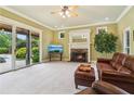 Cozy living room features a fireplace, comfortable seating, and sliding doors to the outdoor pool area at 150 Henderson Farm Dr, Woodstock, GA 30188