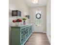 Inviting entryway with a decorative cabinet, hardwood flooring, and stylish lighting at 2501 Painted Buckeye Chase Se, Smyrna, GA 30080