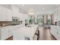 Modern kitchen featuring a large island, white cabinetry, and sleek stainless steel appliances at 2501 Painted Buckeye Chase Se, Smyrna, GA 30080