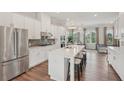 Modern kitchen with a large island, stainless steel appliances, and stylish pendant lighting at 2501 Painted Buckeye Chase Se, Smyrna, GA 30080