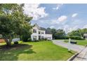Charming two-story home with a lush green lawn, beautiful landscaping and a circular driveway at 1670 Burnt Oak Way, Dacula, GA 30019