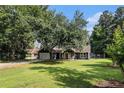 Well-kept single-Gathering home featuring a green lawn and a charming covered front porch at 50 Blackberry Lane, Covington, GA 30016