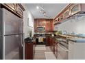 Kitchen featuring granite countertops, stainless steel appliances, and wine glass rack above peninsula at 620 Peachtree Ne St # 911, Atlanta, GA 30308