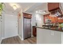 Kitchen with granite countertops, stainless steel appliances, and wooden cabinets at 620 Peachtree Ne St # 911, Atlanta, GA 30308