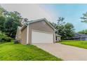 View of the home's side and garage, highlighting the concrete driveway and well-kept lawn at 1333 Trailwater Chase Nw, Acworth, GA 30102