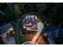 Stunning aerial view of a two-story home featuring a sparkling pool, backyard and lush landscaping at 3217 Aberrone Pl, Buford, GA 30519
