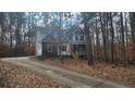 Charming two-story home nestled among mature trees and a private drive at 488 Morris Rd, Hiram, GA 30141