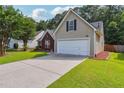 Charming home featuring a well-manicured lawn, a two-car garage and a cozy brick facade at 4920 Markim Forest Ln, Sugar Hill, GA 30518