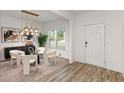 Stylish dining area with modern light fixture and neutral tones at 939 Brittfield Way, Loganville, GA 30052