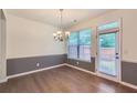 Dining room featuring hardwood floors, neutral paint, and modern chandelier at 3192 Spicy Cedar Ln, Stonecrest, GA 30038