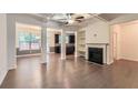 Open concept living room featuring hardwood floors, fireplace, coffered ceilings, and elegant columns at 3192 Spicy Cedar Ln, Stonecrest, GA 30038