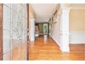 Inviting foyer with hardwood floors, decorative glass door, and elegant trim work at 317 Saint Pauls Ct, Stockbridge, GA 30281
