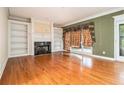 Spacious living room with hardwood floors, fireplace, and built-in shelving at 317 Saint Pauls Ct, Stockbridge, GA 30281