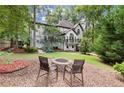 A serene backyard featuring a fire pit and ample space for outdoor activities and entertaining at 4300 May Apple Dr, Alpharetta, GA 30005